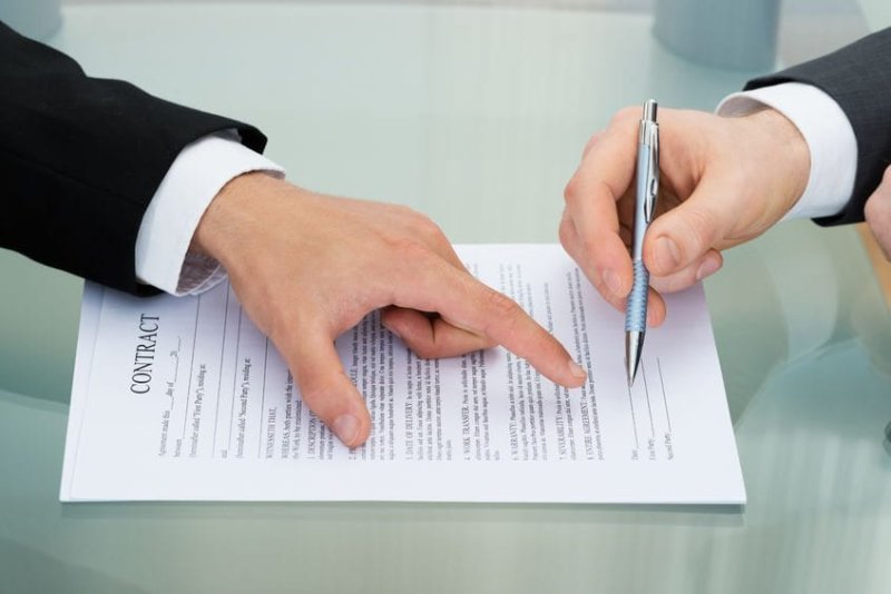 40870633 - person pointing on paper to sign on contract
